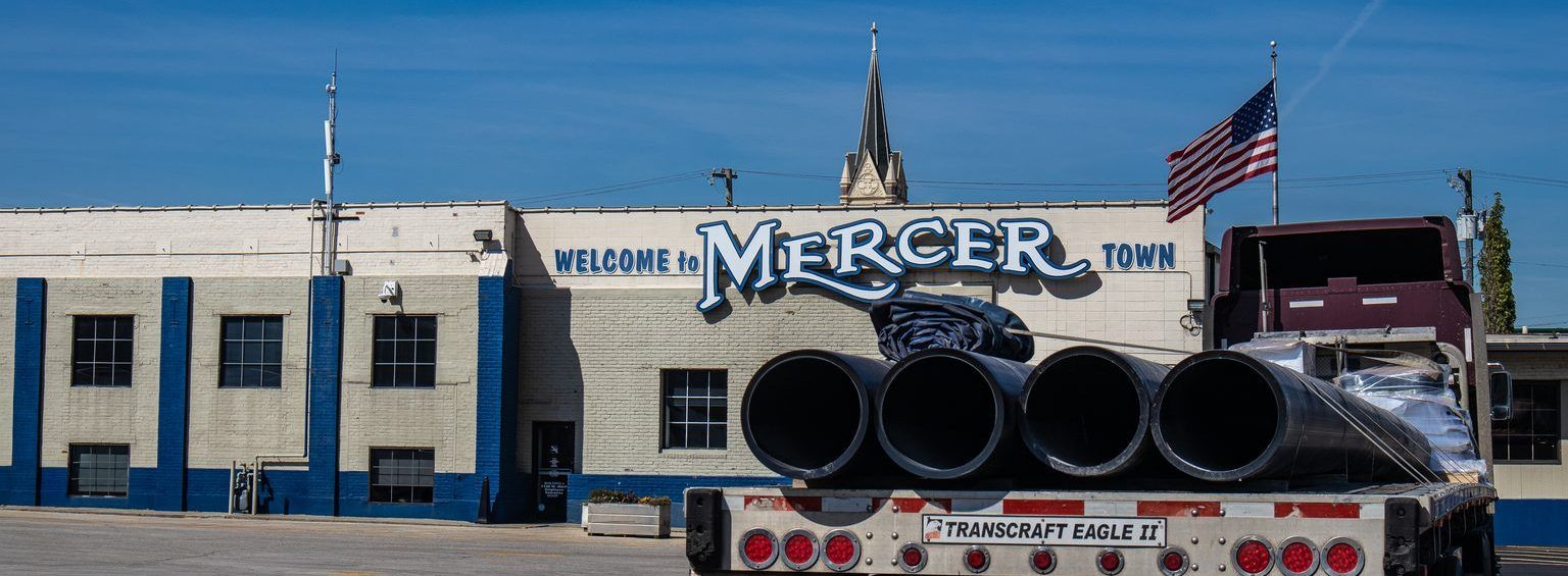 Mercer Transportation headquarters in Louisville, Kentucky, with a flatbed load of plastic pipe